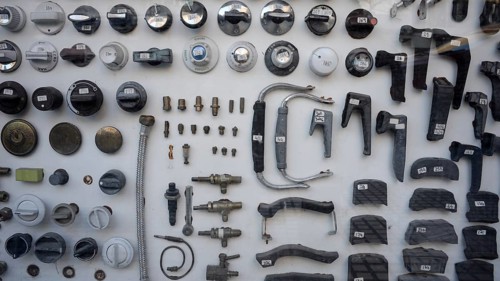 View into the shop window of an antiquarian plumbing shop with numbered spare parts of all kinds,