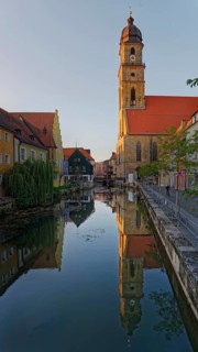 The setting sun bathes everything in warm light and reflects the Basilica of St Martin in the River
