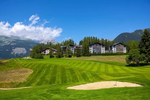 Crans Sur Sierre Golf Course with House and Mountain View in Crans Montana in Valais, Switzerland,