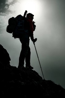 Mountaineer with luggage in the background Rätikon mountains with cloudy sky, Tschagguns, Rätikon,