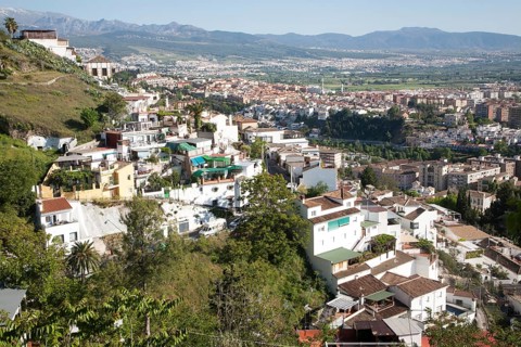 Residential suburban housing area in Granada, Spain with snow capped Sierra Nevada mountains in