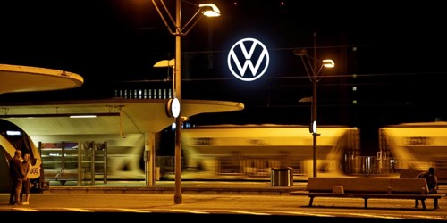 Wolfsburg main station at night with illuminated VW logo at the Volkswagen AG main plant, Lower