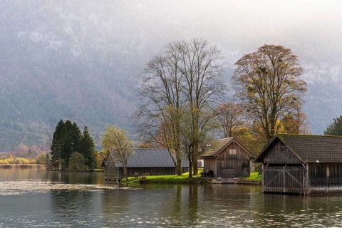 Lake Hallstatt near Steeg. Some boathouses. Autumn, backlight. Lake Hallstatt, Salzkammergut, Upper