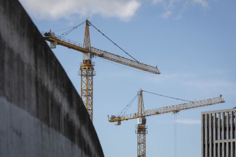 Two construction cranes in front of a blue sky in the Mitte district of Berlin, 28/03/2024