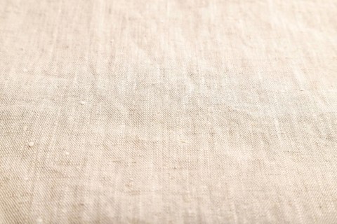 Fragment of smooth white linen tissue. Side view, natural textile background and texture