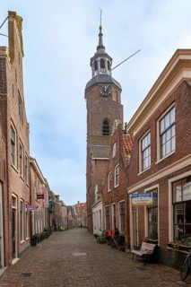 Alley with traditional houses and church in the town of Blokzijl, province of Overijssel,