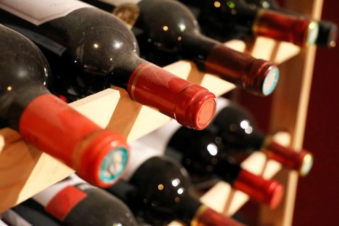 Wine cellar with red wine bottles