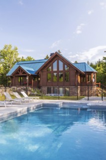 In-ground salt water swimming pool and brown stained milled Eastern white pine timber and flat log