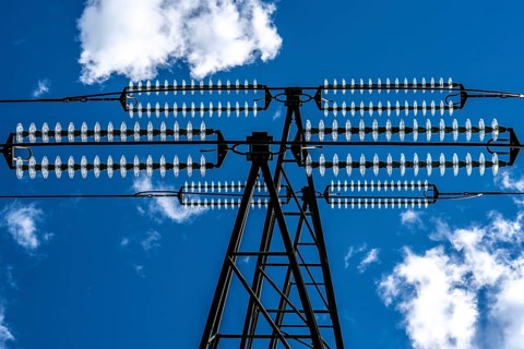 Insulators made of glass on a high-voltage line, they hang on the pylons as a suspension device