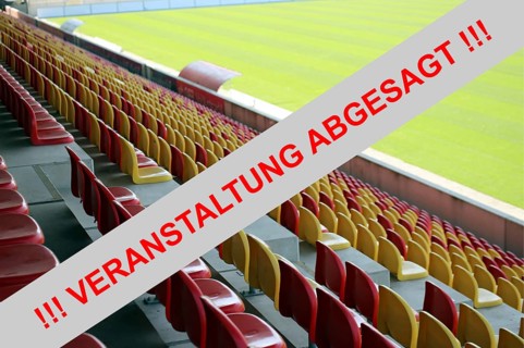 Symbolic image: Red sign with the message (event) cancelled with an empty stadium in the background