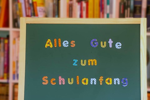 School blackboard with the inscription Happy first day at school