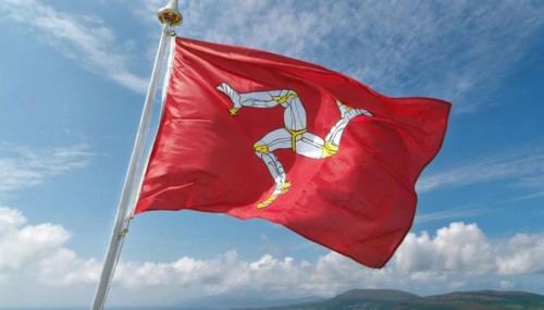 The flag of the Isle of Man, Great Britain, flutters in the wind