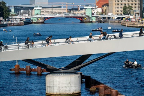 Cyclists on the Lille Langebro cycle and pedestrian bridge over the harbour, Copenhagen is