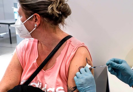 A woman receives a booster vaccination from Moderna against Covid 19 at the Schönefeld vaccination