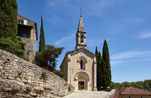 La Chapelle l'Eglise with mediterranean cypresses (Cupressus sempervirens) in La Roque-sur-Cèze,