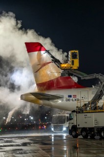 Winter at Frankfurt Main Airport, FRA, Austrian aircraft being de-iced by de-icing vehicles, Hesse,