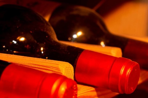 Wine cellar with red wine bottles