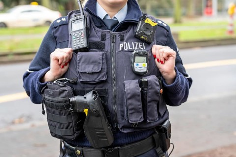 Police, policewoman with equipment waistcoat, CO measuring device device, above a bodycam, first