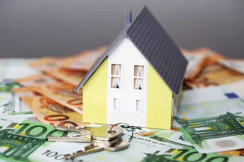 Concept photo with model house, euro notes and coins