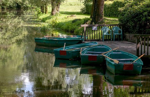 Green boats on the wooden jetty, Alstätter Aa near the Haarmühle, Ahaus-Alstätte, Münsterland,