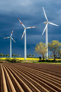 Wind turbines on a rape field, dark rain clouds, in the Rhenish lignite mining area, near