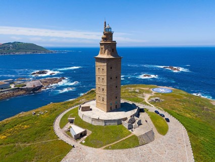 A striking lighthouse structure standing on a picturesque coastline surrounded by the deep blue sea
