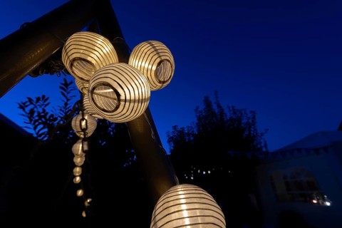 Lanterns, paper lanterns, fairy lights in a garden, blue hour, Germany, Europe