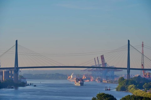 Köhlbrand Bridge over the Elbe, with passing ships and harbour cranes in the background, Hamburg,