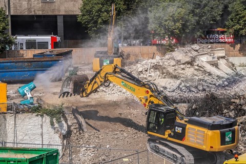 Water cannon, snow cannon, sprays water onto the construction site on Haroldstraße, against dust