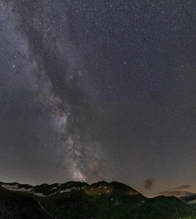 Nocturnal starry sky over the Furka Pass in the Swiss Alps. The night photograph shows the stars of
