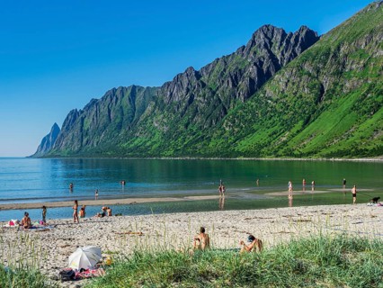 Beach Ersfjordstranden, fjord Ersfjord, public recreation area, summer, people go swimming, view to