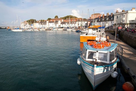 Colourful fishing boats in the harbour at Weymouth, Dorset, England, UK