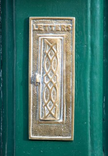 Historic brass letter box on door, Devizes, Wiltshire, England, UK