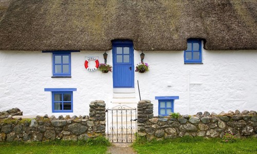 Traditional thatched whitewashed cottage in Porthallow village, Cornwall, England, United Kingdom,