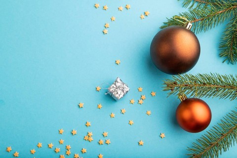 Christmas or New Year composition. Decorations, bronze balls, fir and spruce branches, on a blue
