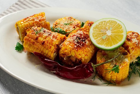 Grilled corn with spices, top view, no people, homemade