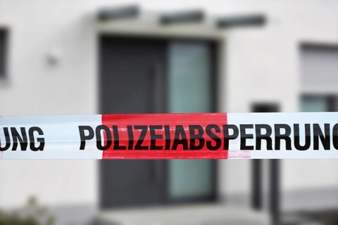 Symbolic image: Barrier tape with the inscription police cordon, in the background a residential