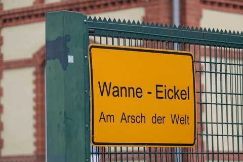 Sign on a building, Wanne-Eickel Am Arsch der Welt, belongs to the city of Herne, Ruhr area, North