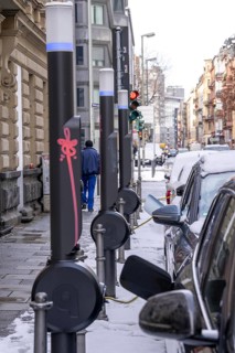 Winter in the city, electric cars charging at charging stations in the city centre of Frankfurt,