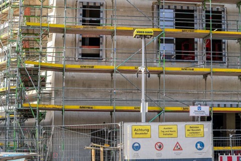 Large construction site, scaffolded shell of an office and commercial building complex, Video