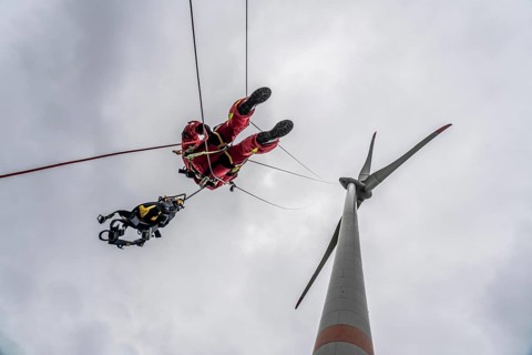 Height rescuers from the Oberhausen fire brigade practise abseiling from a wind turbine from a