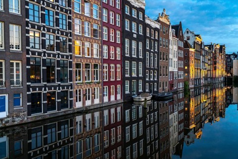 Canal houses on the Damrak, in the centre of the old town of Amsterdam, harbour, starting point of