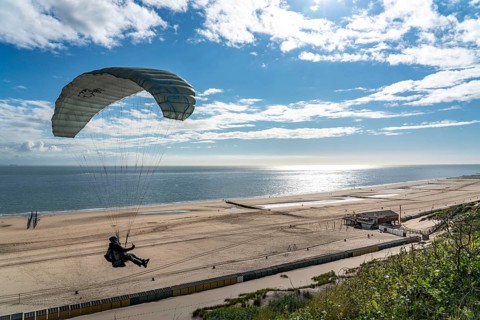 Paragliders along the dunes of Zoutelande, in Zeeland, South Holland, Netherlands