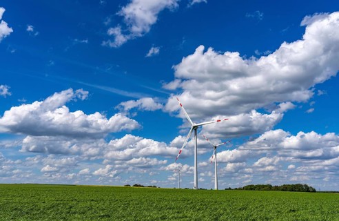 Wind farm, wind turbine, wind turbines from the manufacturer Enercon, blue sky with many white