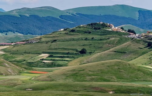 Mountain landscape on the edge of the Pian Grande di Castelluccio di Norcia plateau in the Monti