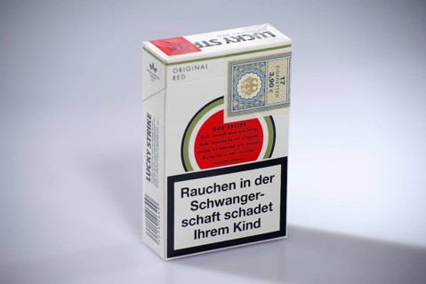 Cigarrette box Lucky Strike, back with tax band arole and warning Smoking during pregnancy harms