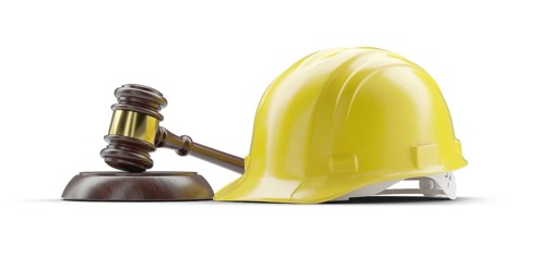 Yellow hard hat and gavel isolated on a white background