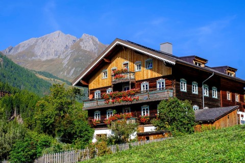 Farmhouse decorated with flowers. Burg district, Kals am Großglockner, East Tyrol, Austria, Europe