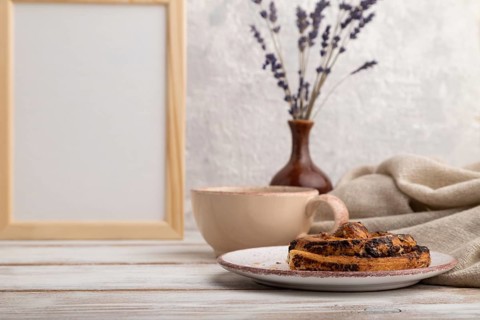 White wooden frame mockup with lavender in ceramic vase, linen textile, cup of coffee and bun on