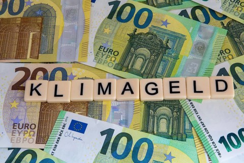 Symbolic image of climate money: Letters on euro notes display the word climate money